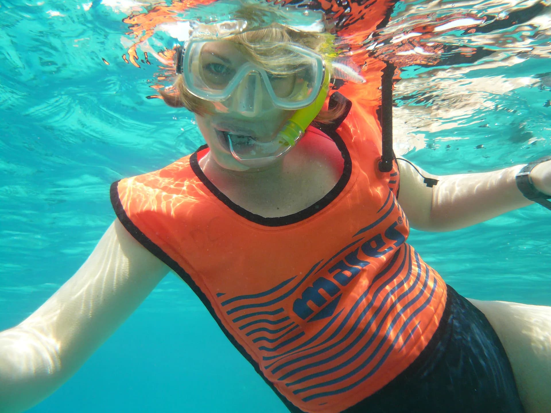 Snorkeler exploring shallow water with marine life